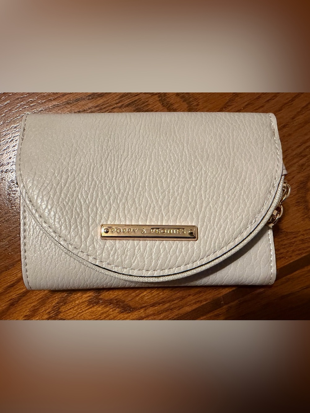 Dooney & Bourke Cream Pebbled Leather Wallet with Gold Tone Plaque